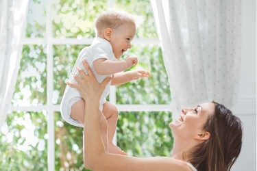 Mom lifting her baby in the air