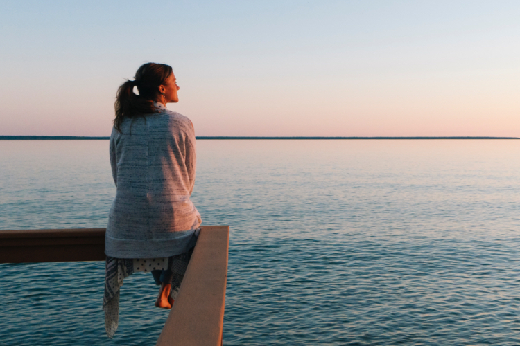 Woman looking into the distance by the sea